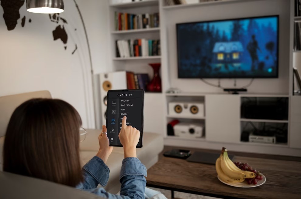 a young woman using a table to set up a smart TV