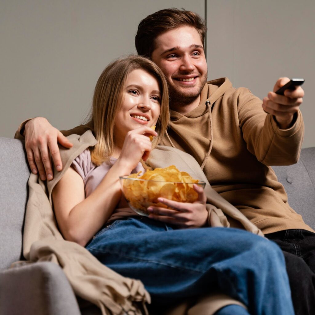 A woman and a man watching TV