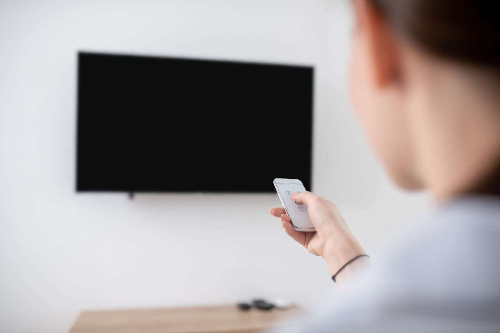 A woman turns on the TV