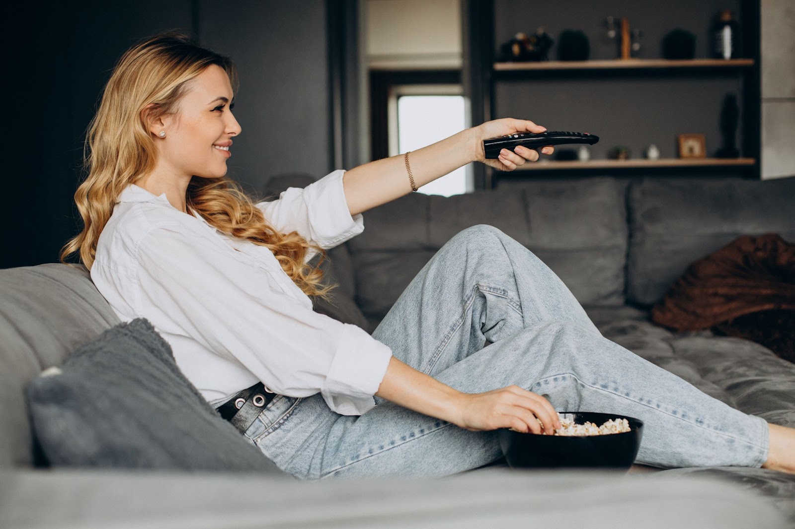 Woman eating popcorn and watching TV